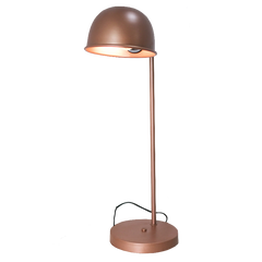A copper colored, vintage-style study desk lamp with a matte finish, standing upright with light shining from the shade.
