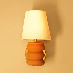 Terra Contour Wall Sconce: terracotta-finish ceramic body with metal frame wall mounted on wall