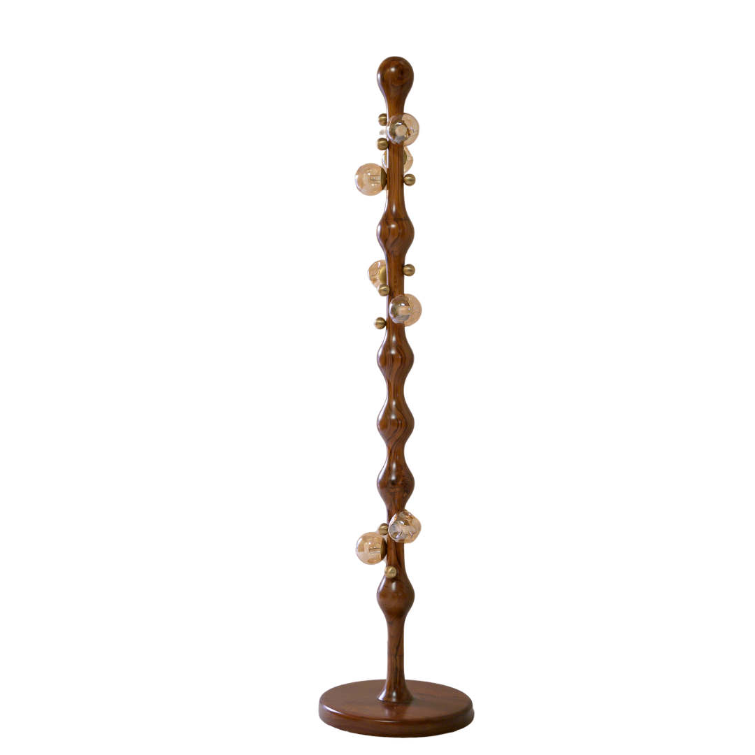 A tall, narrow wooden floor lamp with a glossy brown finish, featuring a wavy vertical shaft, a round base, and several clear glass globe bulbs with gold-toned caps.