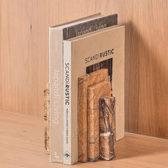 Stepper Bookend made of Fossil Brown Marble standing upright on a wooden surface against a wood-paneled background. 