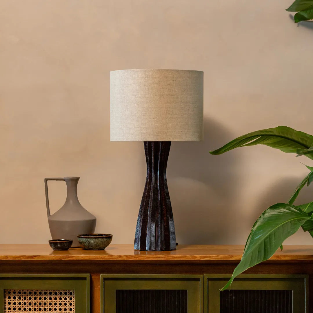 Garnet Table Lamp with a textured base on a wooden surface