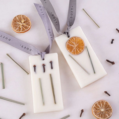 Lemon Grass & Clove Wax Tablet - Set of 2, tablets on grey Doft ribbons with dried lemon slices and cloves, top view