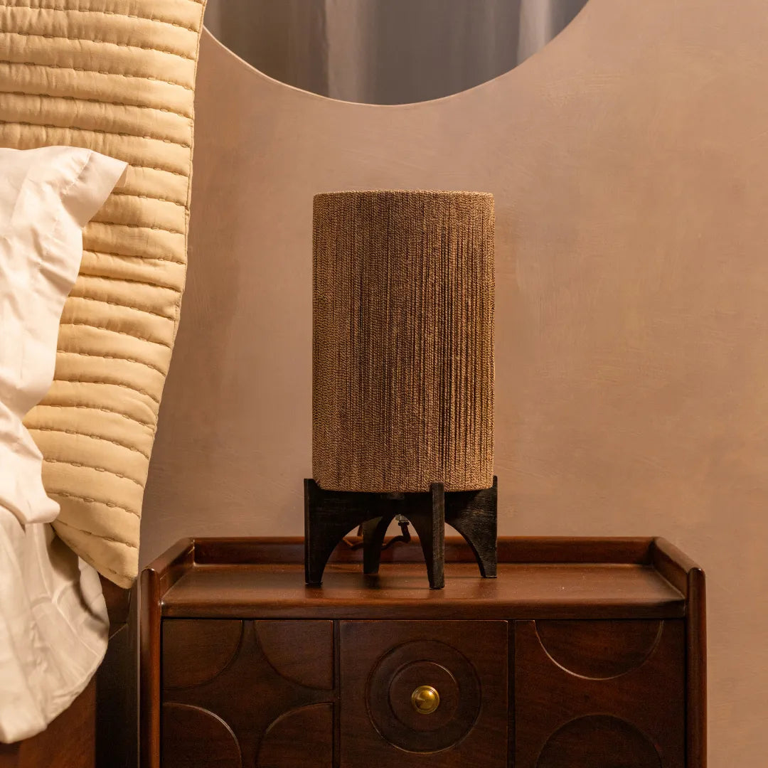 Textured Ambra Table Lamp on a wooden nightstand against a beige wall