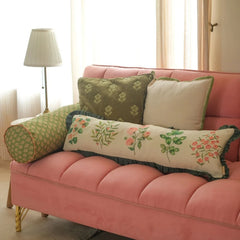 Fiora Ivory Linen Lumbar Cushion Cover on pink sofa with bolster and square cushions