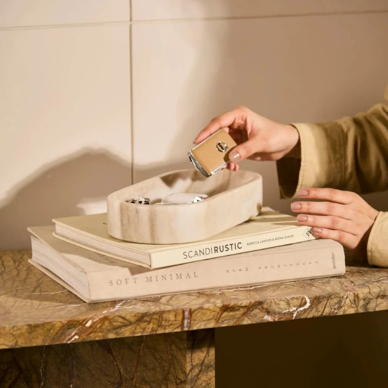 Marble Bowl - Beige - Styled on Books, Hand Placing Item in Oval Bowl