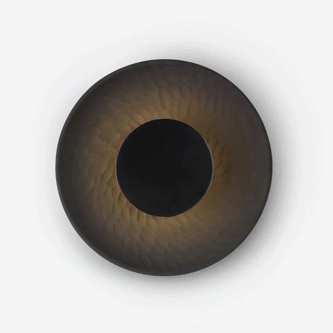 Disc wall light black stoneware disc and steel mount mounted on white wall