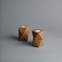 Two Chamfer Tealights plywood candle holders with geometric designs on a gray background
