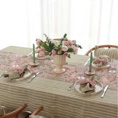 Valley Rose Linen Table Runner on dining table with pink roses and green candles, angled view
