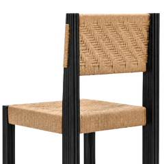 Tessa Dining Chair angled close-up of jute backrest, seat and fluted black frame posts