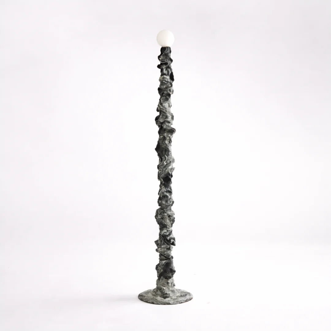 Decorative floor lamp with a hand-sculpted textured base 