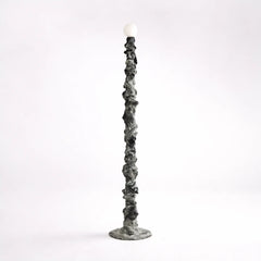 Decorative floor lamp with a hand-sculpted textured base 