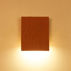 Designer wall lamp with ambient accent lighting looks like a wooden square wall light fixture on a beige wall