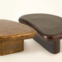 Two unique wooden coffee tables with curved designs on a white background