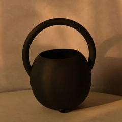 Unique Halo Vase kettle design on a beige surface with a beige background