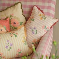 Rosalia Dusty Rose Linen Oblong Cushion Cover on pink gingham armchair with floral cushions