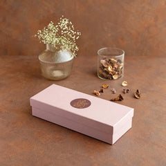 Lotus Blossoms _ Gift Box, closed pink gift box with floral emblem on the lid