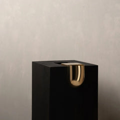 A modern black rectangular Bookcase Vase or planter with a polished gold metallic U-shaped accent on the front.