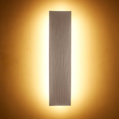 A vertical beige color wall sconce to style and brighten up your space.