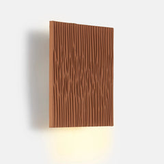 Down Light ceramic wall sconce with wavy texture on a white background