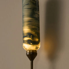 Close look of wall sconce outdoor light with a hand-finished marble-effect glass in green.