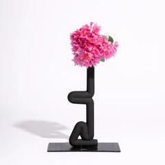 Modern black Sirsasana Vase with pink flowers on a white background