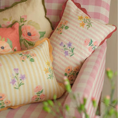 Rosalia Amber Linen Oblong Cushion Cover layered on pink gingham armchair, close view