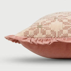Pink textured pillow on a light gray background