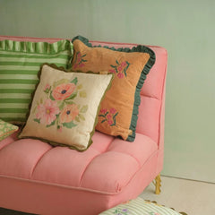 Annabella Amber Linen Cushion Cover on pink sofa with striped and ruffled cushions