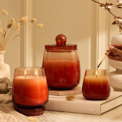 Cosmic Hues - Lid Jar Candle | Orange | Summer Nectar, three sizes styled on books with dried grasses