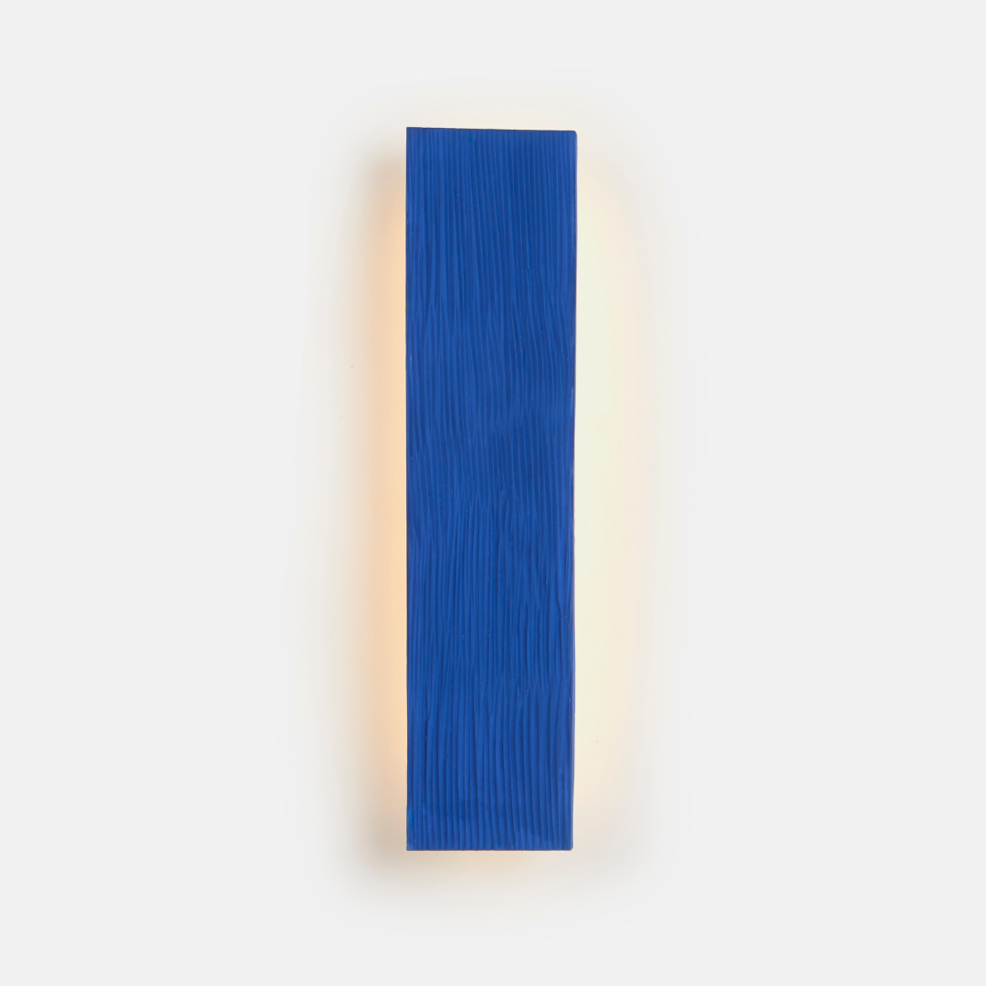 A vertical blue wall sconce fixture with a white background.