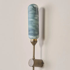 Decorative wall sconce outdoor light with a hand-finished marble-effect glass.