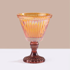 Decorative front view of Sundae - Votive Candle - Amber - Salted Vanilla, amber iridescent ribbed glass on burgundy pedestal.