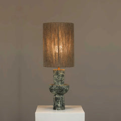 Decorative Natura Table Lamp with a textured shade and marble base on a gray background