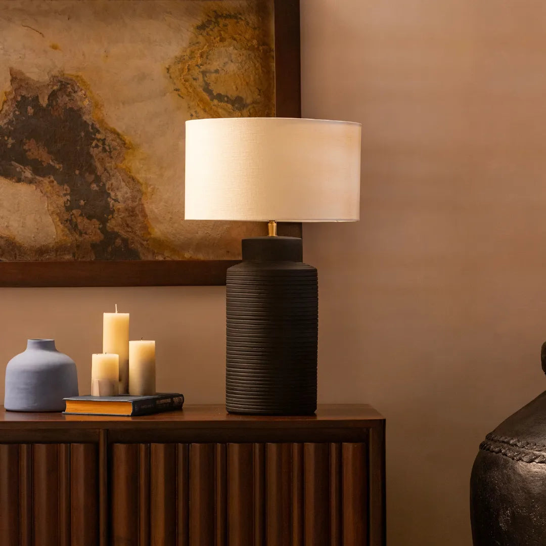 Jasper Table Lamp with white lampshade and wooden vase type base on a wooden side table