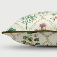 Side view of Eden Rose Linen Cushion Cover featuring a cream background with a green trellis pattern, botanical illustrations, and a thin olive green piping trim.