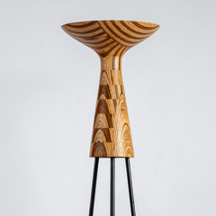 Hourglass Floor Lamp close-up detail of its upcycled-plywood hourglass form on a black metal legs
