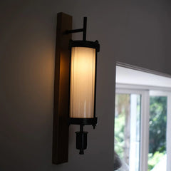 Edison Column Wall-mounted light fixture with a beige lampshade on a neutral wall.