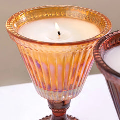 Close view of Sundae - Votive Candle - Amber - Salted Vanilla, lit wax in amber iridescent ribbed glass