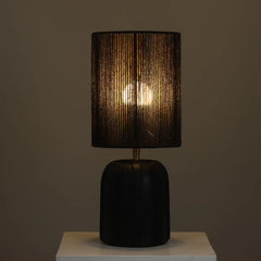 Black Elara Table Lamp with textured shade and black vase type base on a neutral background