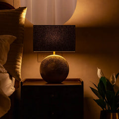 Brillo Table Lamp combination of aluminium base and exquisite handloom fabric with warm lighting in a bedroom setting