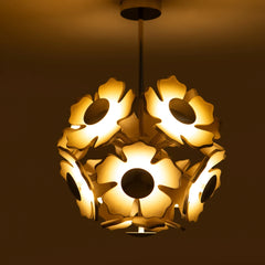 Decorative ceiling light fixture with floral design on a dark background