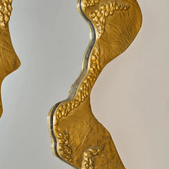 Kinara mirror with aluminium gold intricate designs on a gray background