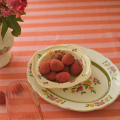 Linea Ruffle Dusty Rose Cotton Table Cover with floral plates and bowl of lychees, close view