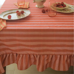 Linea Ruffle Dusty Rose Cotton Table Cover on dining table with plates and lychees, ruffled hem view