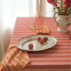 Linea Ruffle Dusty Rose Cotton Table Cover with floral plate, striped napkin and flower jug