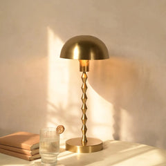 Lumo Table Lamp with gold dome shade and textured rod with round base.