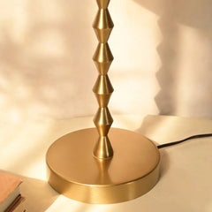 Lumo Table Lamp with gold geometric rod and round base