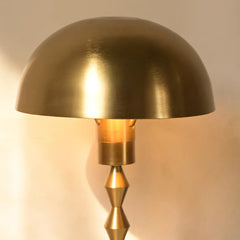 Lumo Table Lamp with gold dome shade close view and with a geometric design rod
