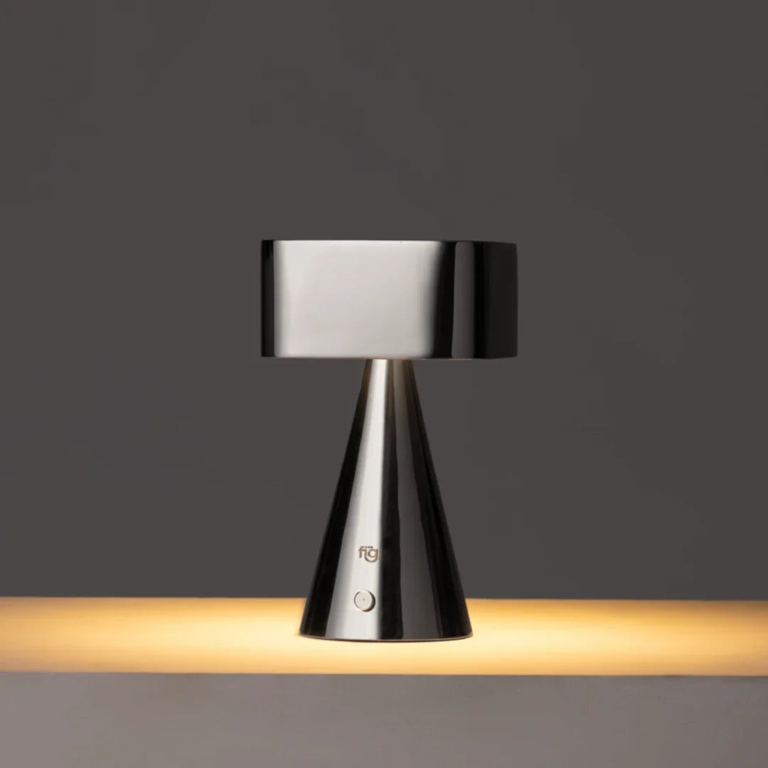 Modern table lamp with black metallic finish on a dark background