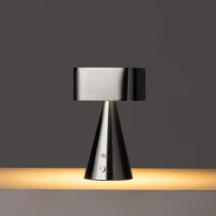 Modern table lamp with black metallic finish on a dark background